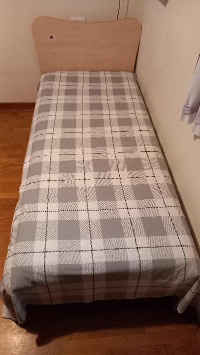 Letto singolo a doghe con materasso.